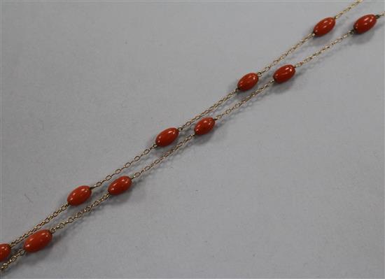 An early 20th century 9ct gold and coral bead set guard chain, 126cm.